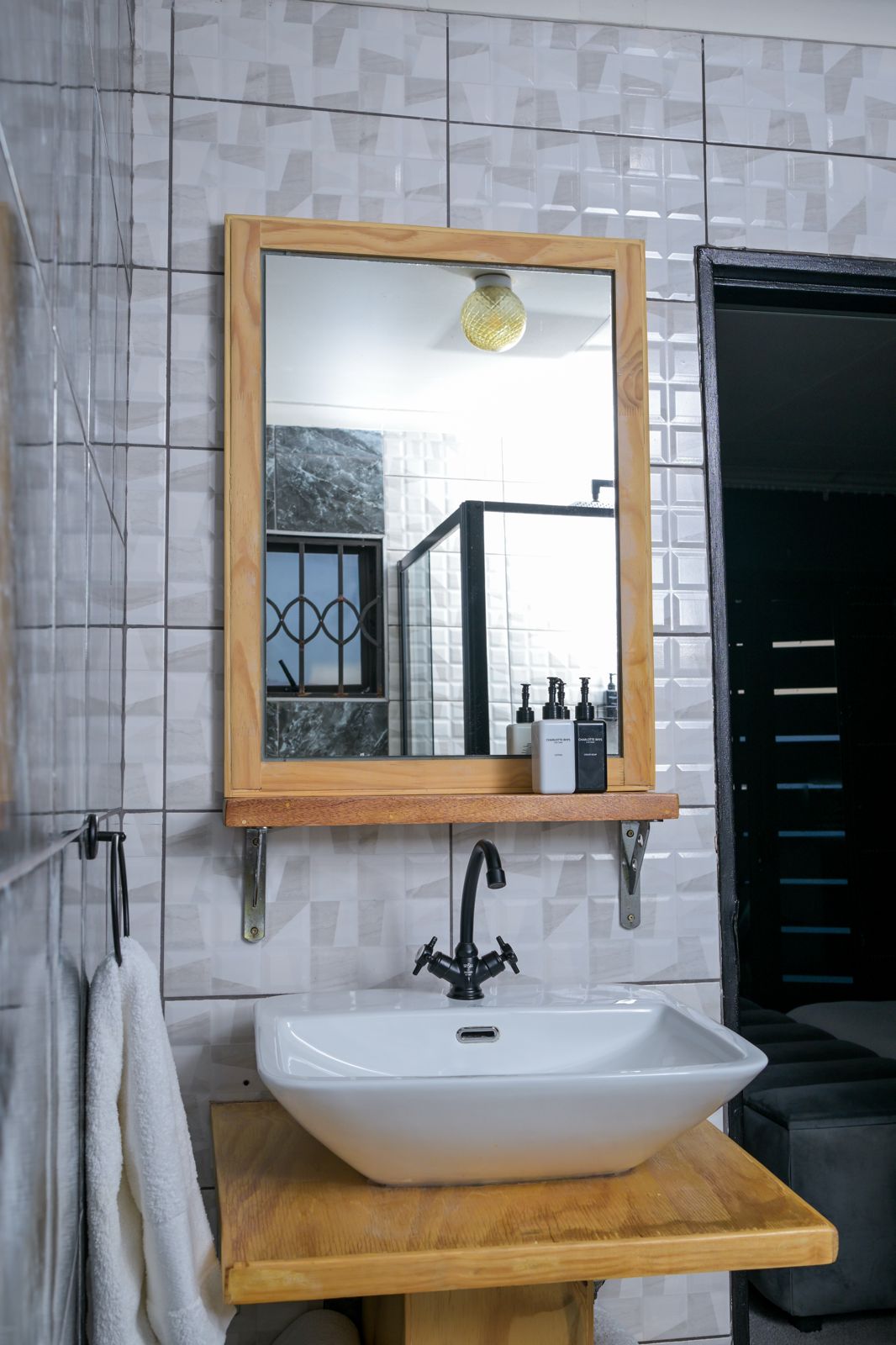 The Dark Room — bathroom basin and wooden-framed mirror