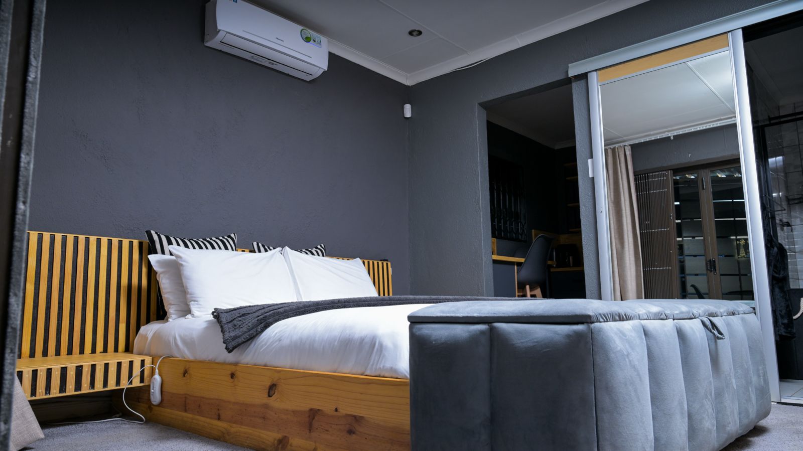 The Dark Room — queen bed with air conditioning above