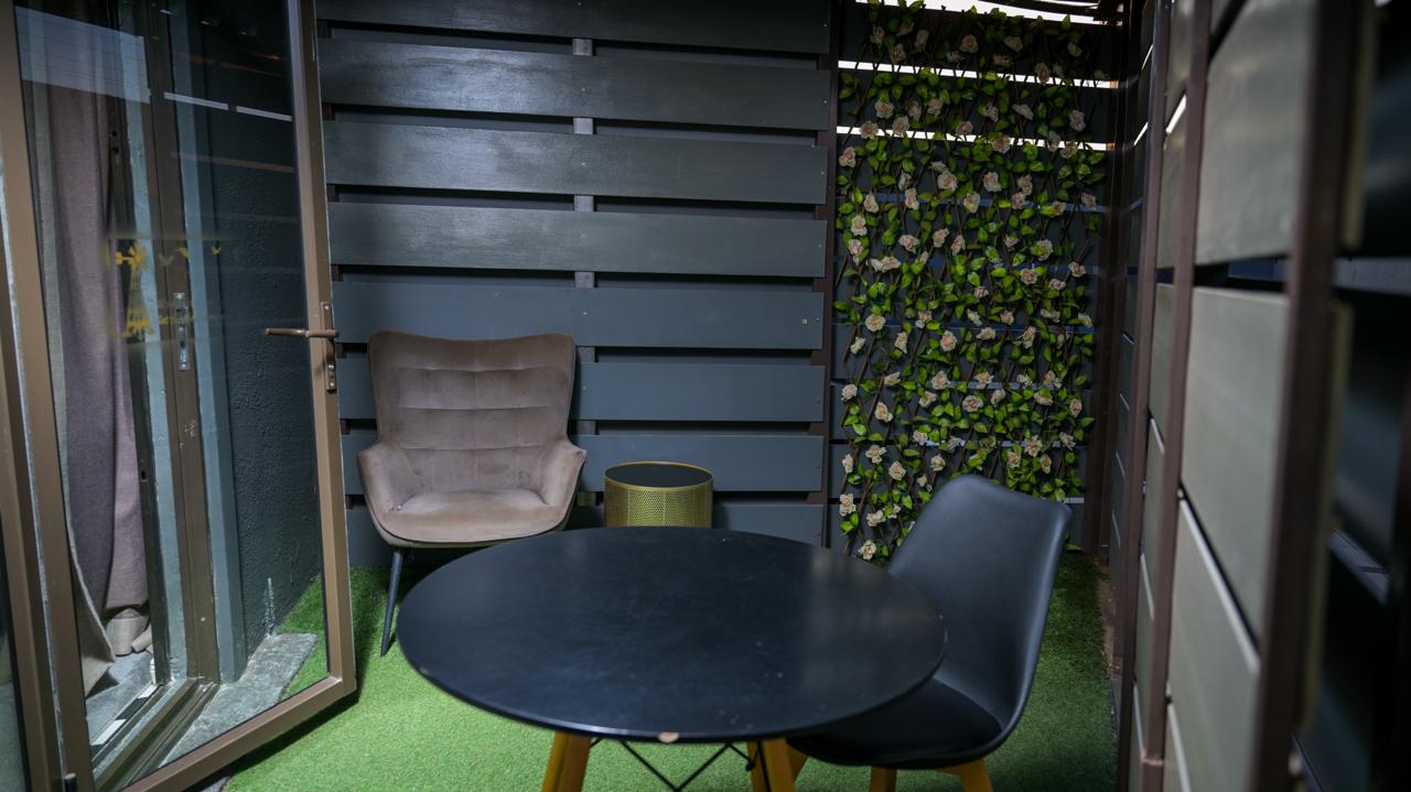 The Dark Room — courtyard table and chairs against the garden wall