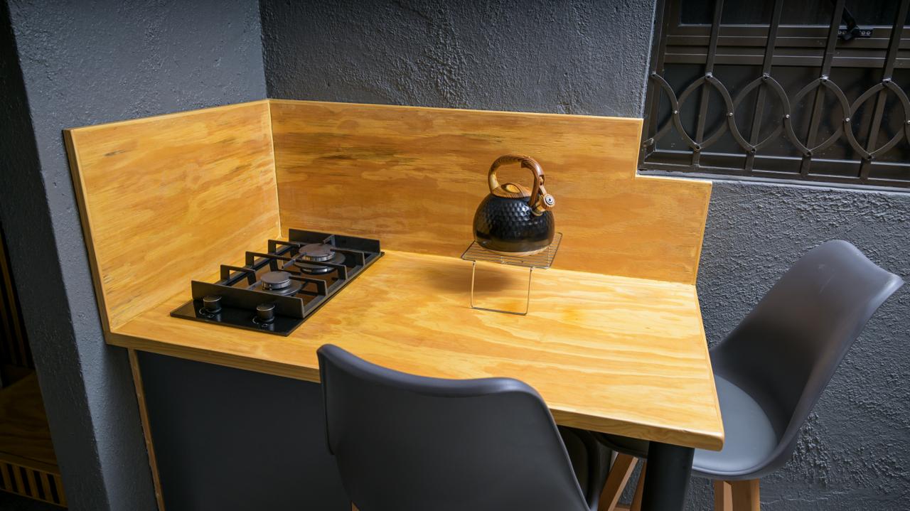 The Dark Room — gas stove and kettle in the kitchenette