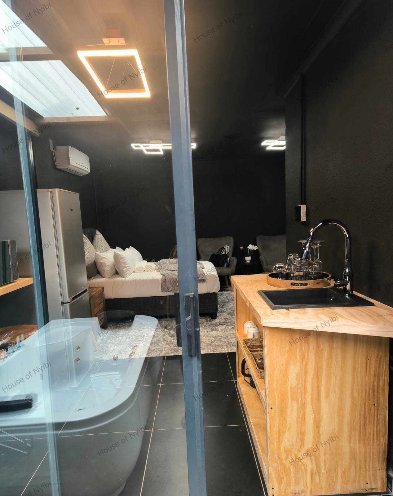 Zululami — view from the room to the private hot tub through glass doors